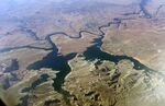 An aerial view of Lake Powell on the Colorado River along the Arizona-Utah border on Sept. 11, 2019. A dam holds back Lake Powell, one of the largest man-made reservoirs in the country. Federal officials sent seven western states a letter this week warning them that they're considering cutting the amount of water that flows through the Colorado River to the Southwest to maintain Lake Powell and prevent it from shrinking to a point at which Glen Canyon Dam could no longer produce hydropower. Consideration of what would be an unprecedented move comes sooner than water officials expected as they reckon with the effects drought and climate change have on their urban and agricultural customers. (AP Photo/John Antczak, FIle )