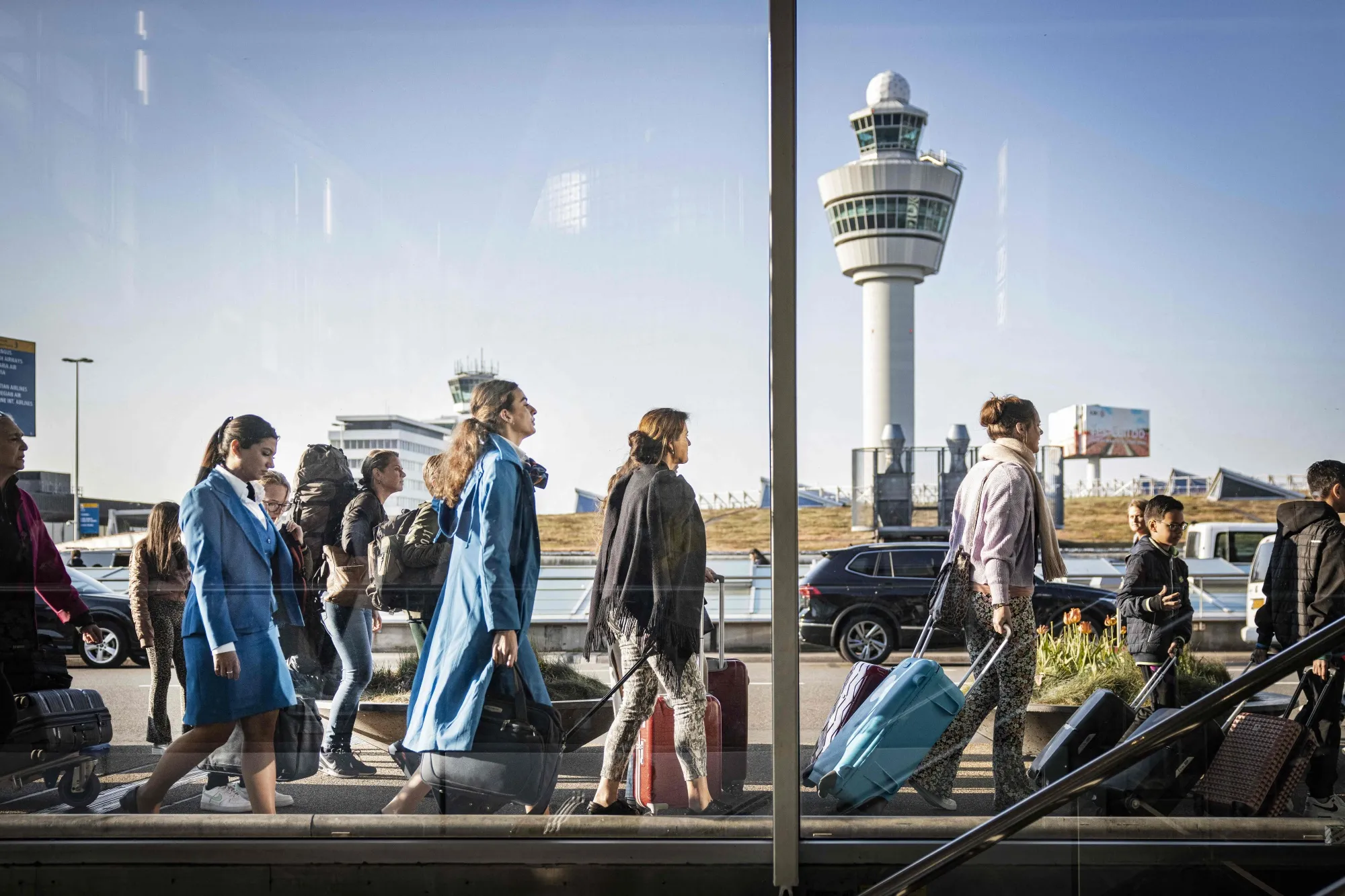 Travellers queue outside a departure hall at Amsterdam’s&nbsp;Schiphol airport.