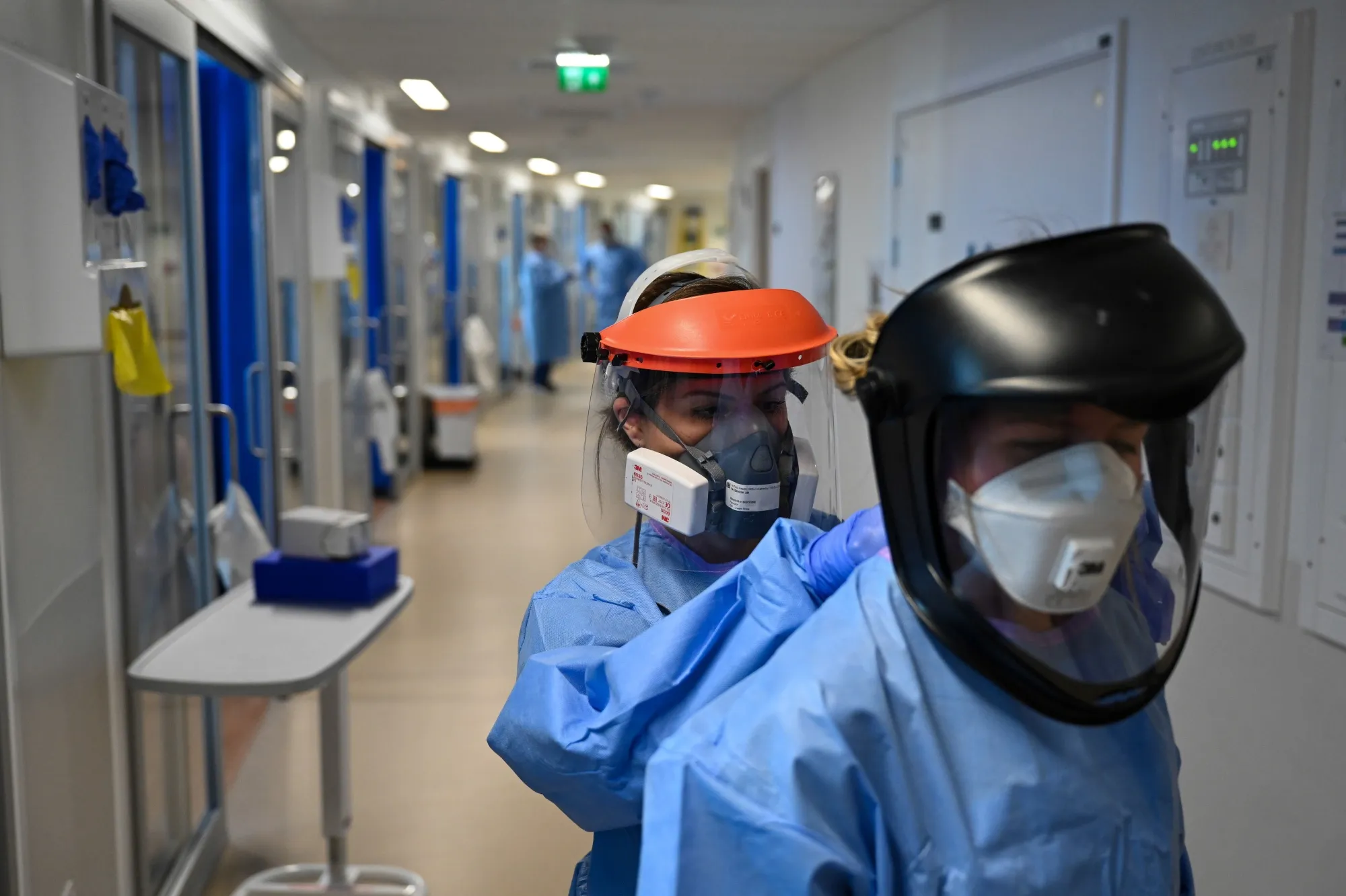 A medical worker adjusts the personal protective equipment of a colleague at a hospital in Cambridge, U.K. on May 5.