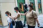 Demonstrators detained by riot police are escorted to police vehicles in the Causeway Bay district during a protest in Hong Kong, China.