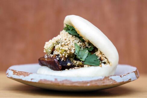 The classic bao is filled with braised pork, peanut powder, and fermented greens.