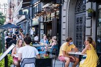 People dine outside in the East Village in New York on July 21.