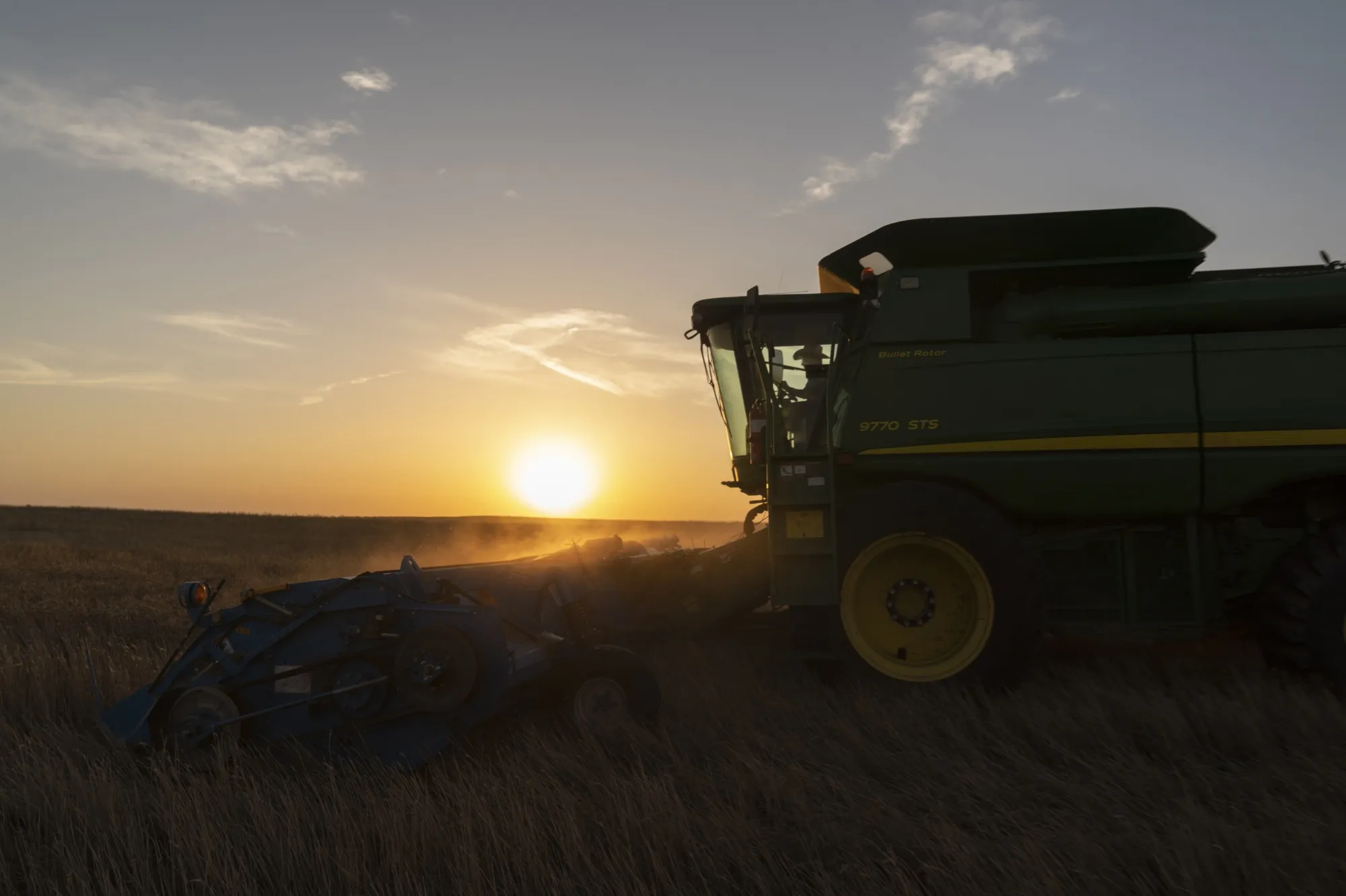 A combine harvests winter wheat in Corn, Oklahoma, US.