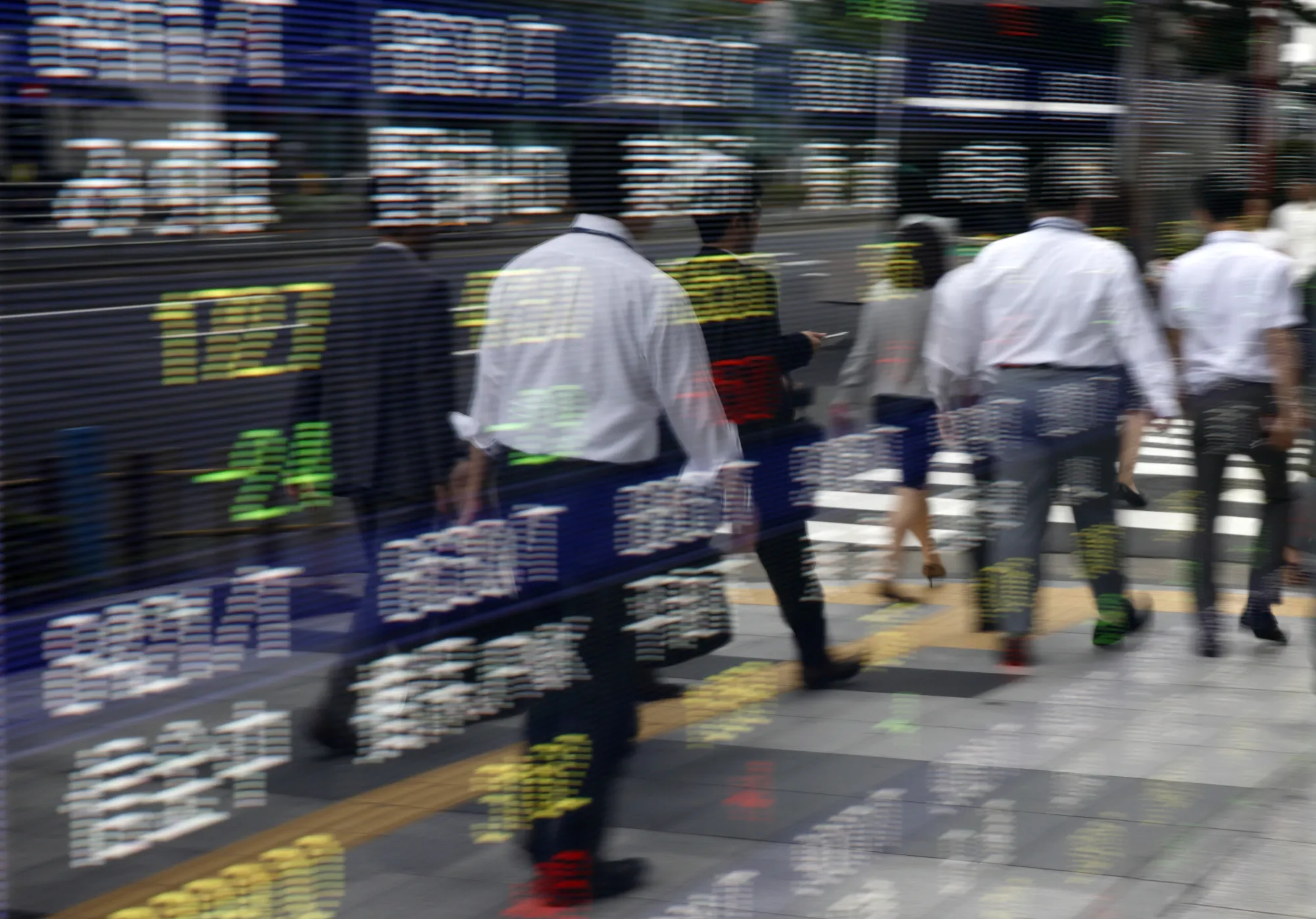 Tokyo Stock Exchange and Stock Boards As Japan Shares Dip With Banks As Volatility Returns to Markets