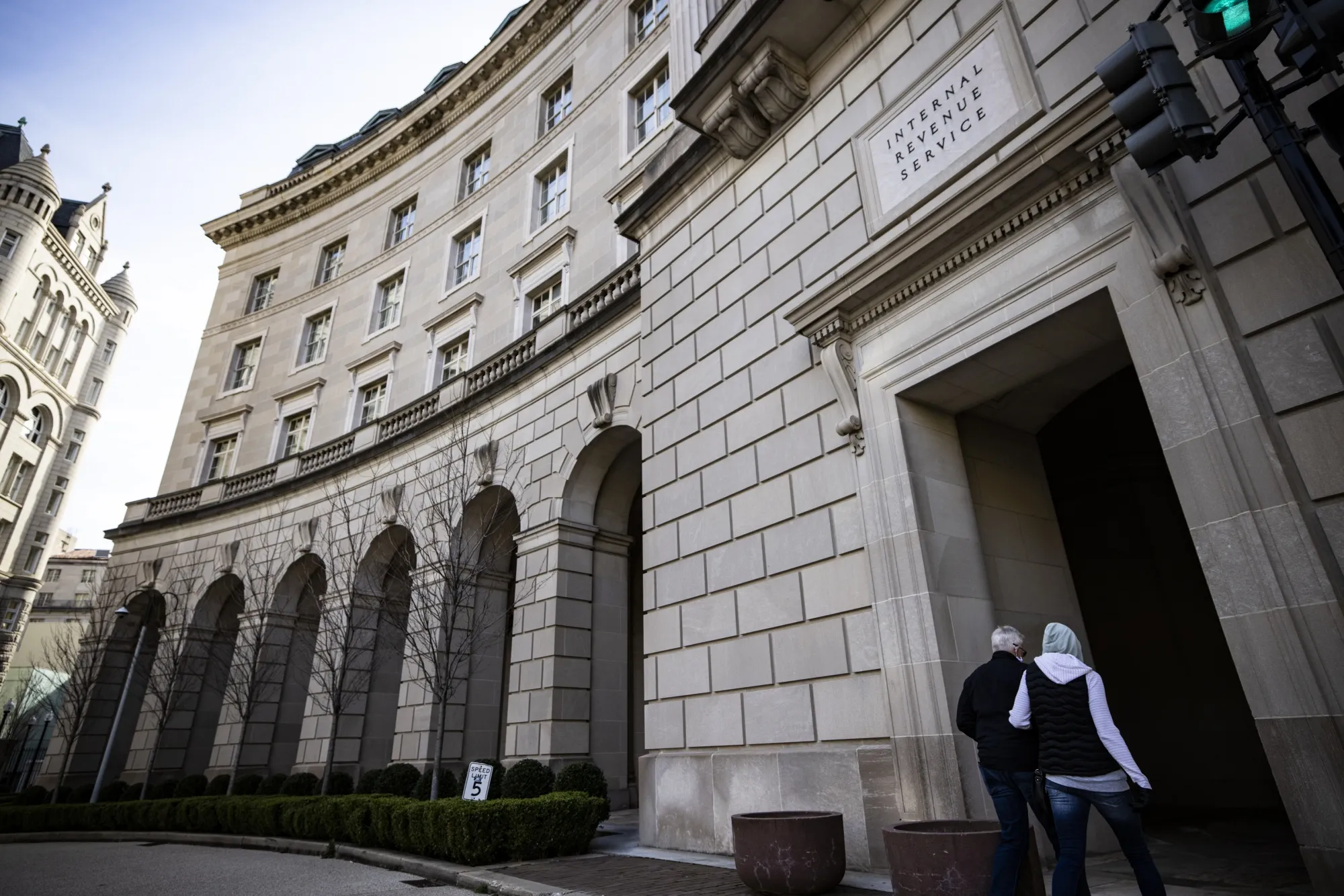 Pedestrians walk in front of the Internal Revenue Service headquarters in Washington.