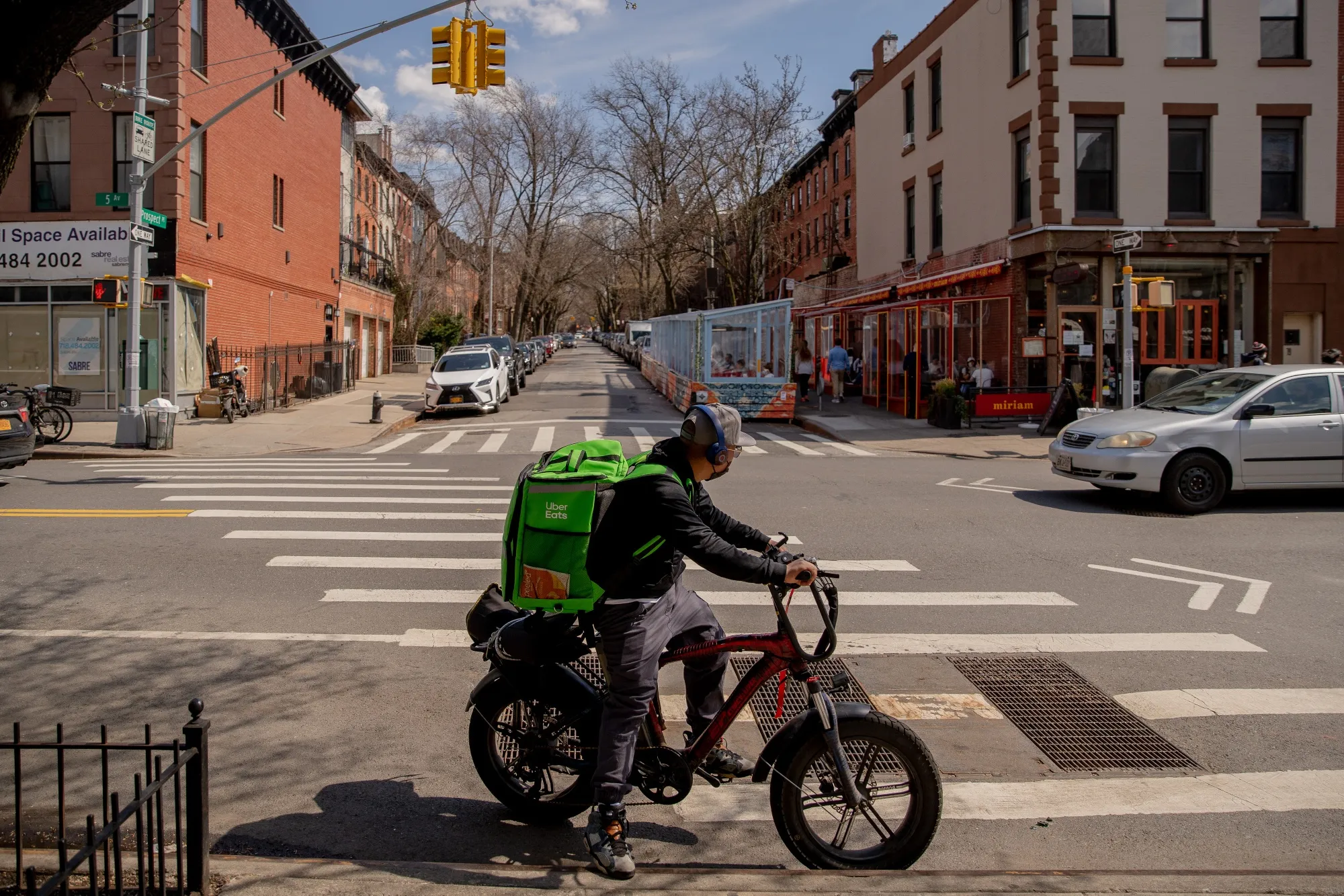 An Uber Eats delivery courier rides a bike in the&nbsp;Brooklyn borough of New York.