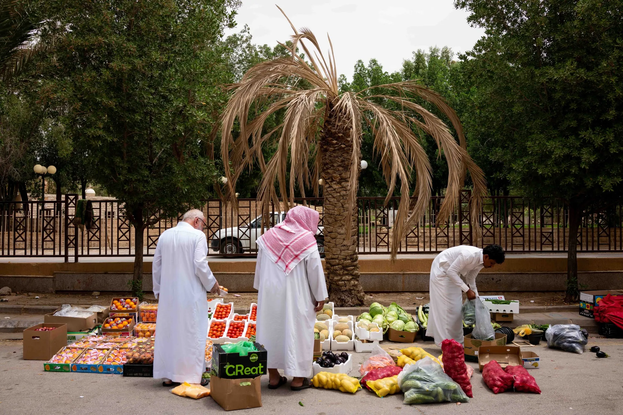 A vendor sells fruit and vegetables on a roadside in Riyadh, Saudi Arabia.