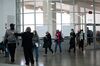 A shift of new volunteers wearing protective masks check in to process absentee ballots for the 2020 Presidential election at the TCF Center in Detroit, Michigan, U.S., on Wednesday, Nov. 4, 2020.