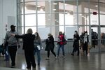 A shift of new volunteers wearing protective masks check in to process absentee ballots for the 2020 Presidential election at the TCF Center in Detroit, Michigan, U.S., on Wednesday, Nov. 4, 2020.
