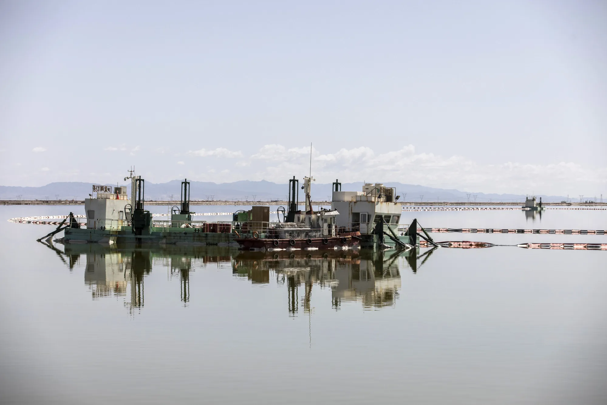 A barge pumps brine from an evaporation pond operated by Qinghai Salt Lake Industry Co. in Golmud, Qinghai province, China.