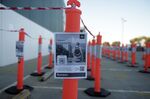 A promotion for the COVIDSafe app hangs from a bollard outside a Bunnings Warehouse store in Melbourne.