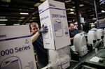 An employee assemble boxes dehumidifiers on the production line at the Ebac Ltd. factory in Newton Aycliffe, U.K., on Monday, Jan. 9, 2017. The pound has weakened by more than 10 percent versus the euro since the referendum, making Ebac's water coolers and dehumidifiers cheaper abroad.
