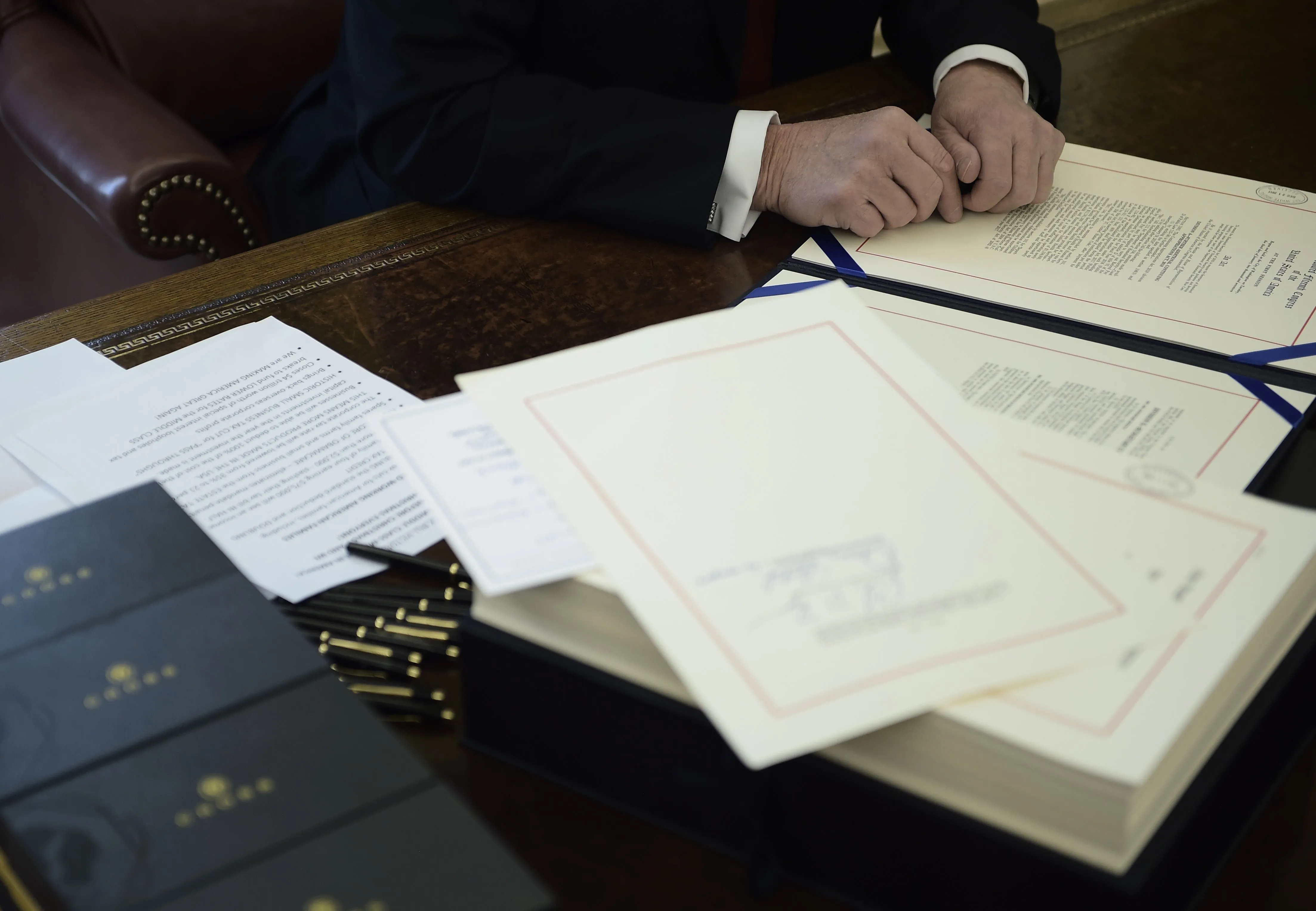 Donald Trump prepares to sign the Tax Cut and Reform Bill on Dec.&nbsp;22.