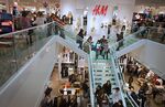 Customers shop during the grand opening of a Hennes &amp; Mauritz AB (H&amp;M) store in Denver, Colorado, U.S., on Thursday, Nov. 10, 2011. Hennes &amp; Mauritz AB, the world's second-largest clothing retailer, will start selling apparel and accessories designed by Gianni Versace SpA next week.
