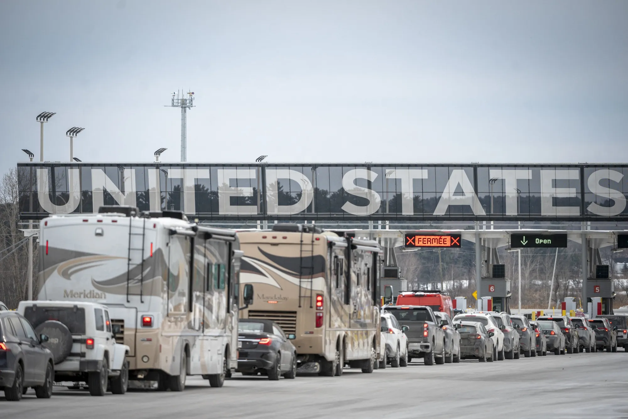 Cars wait in line to enter the United States at a border crossing at the Canada-US border in Quebec.