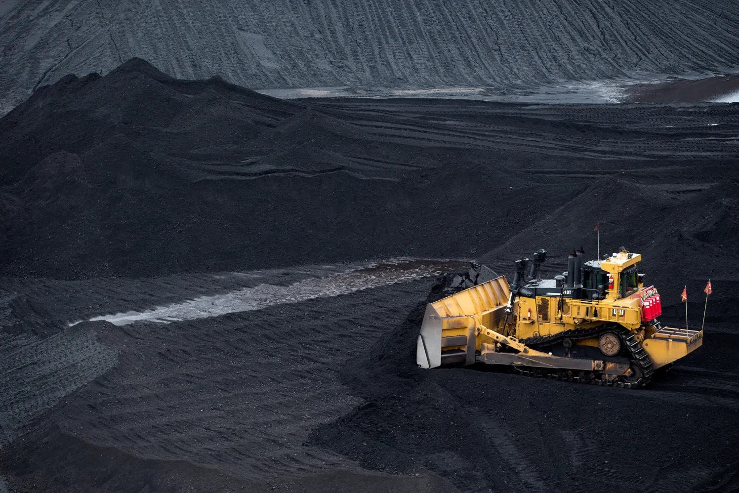 A bulldozer smoothes a coal pile at a storage yard in Baltimore, Maryland, on Sept. 22, 2015.
