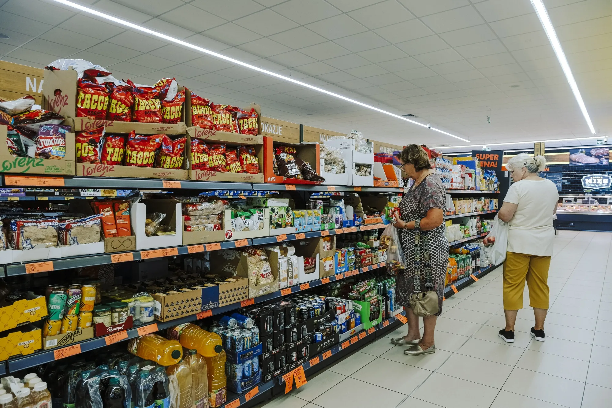Customers browse products in a supermarket in Warsaw.