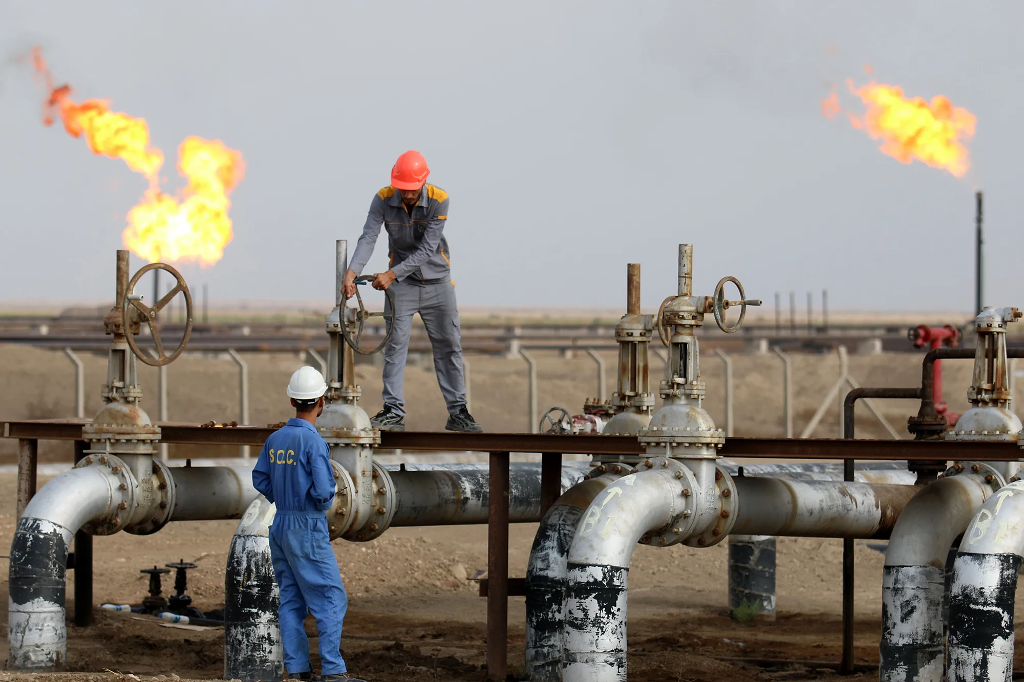 Iraqi labourers work at an oil refinery in the southern town Nasiriyah.&nbsp;