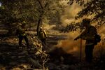Firefighters extinguish a hot spot while working to contain the Apple Fire in Yucaipa, California on Aug. 4.