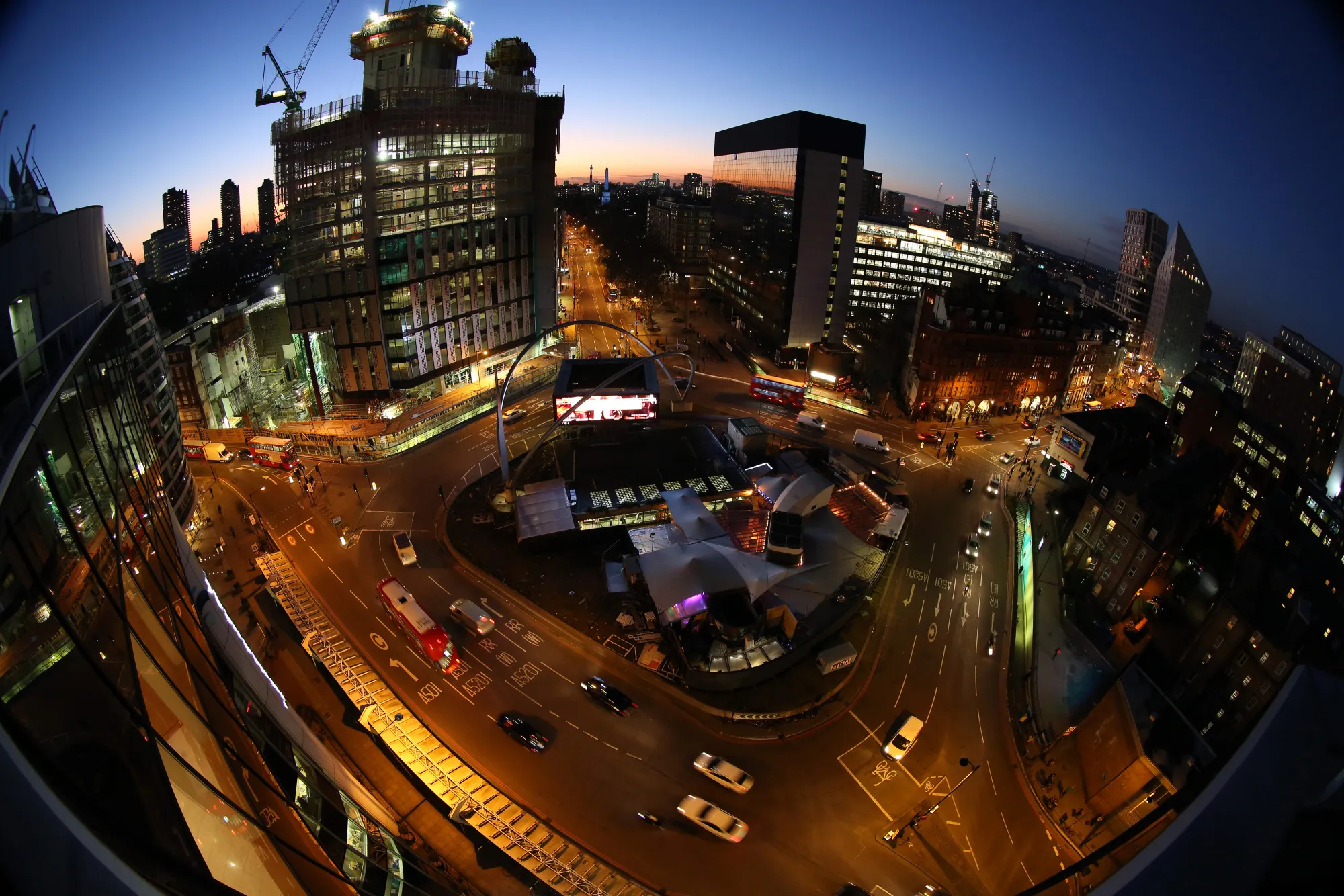 Traffic passes around the Old Street roundabout, also referred to as 'Silicon Roundabout,' in the area known as 'Tech City' at dusk in London.