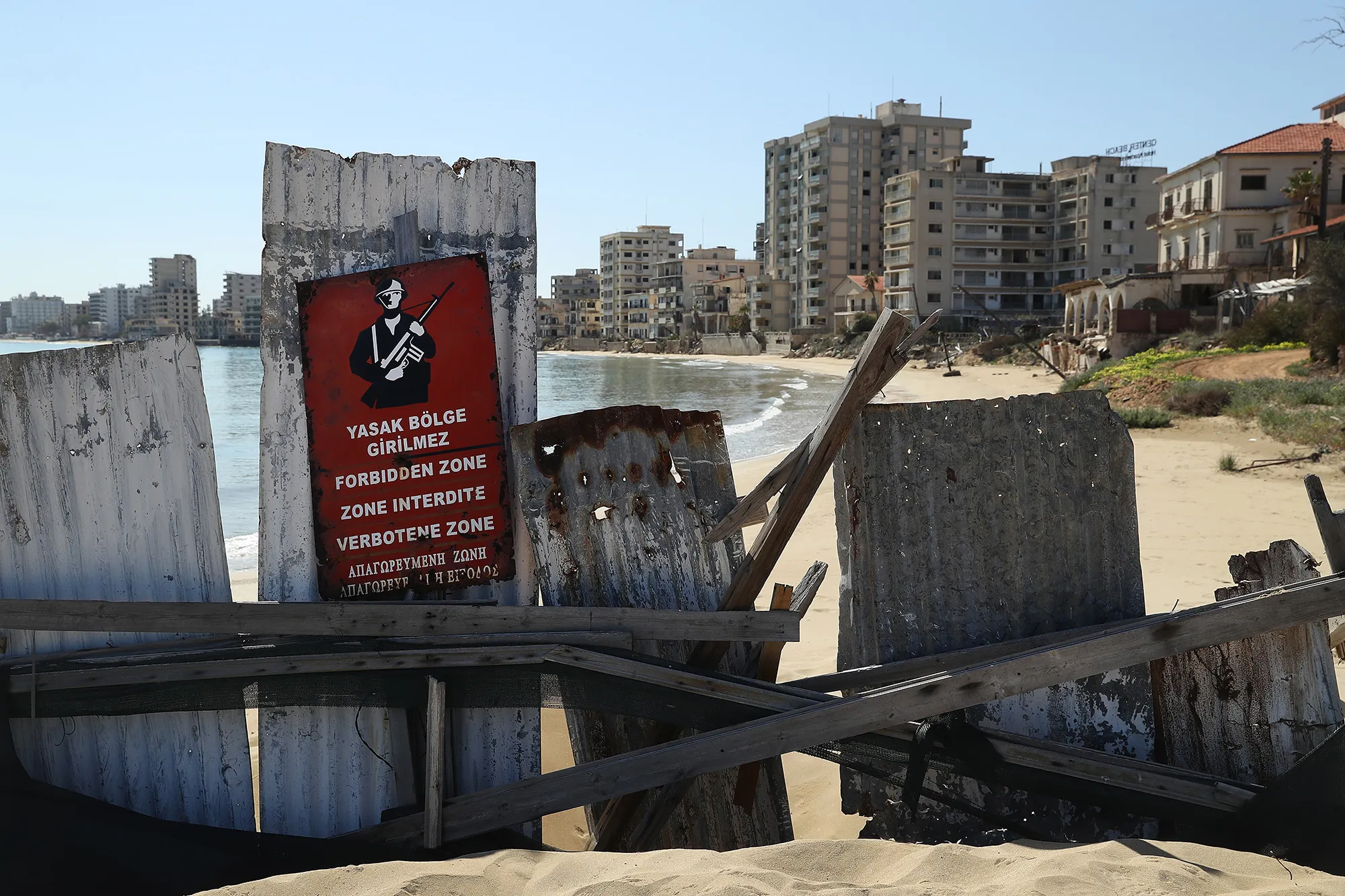 Former hotel buildings stand beyond a barrier in Varosha.