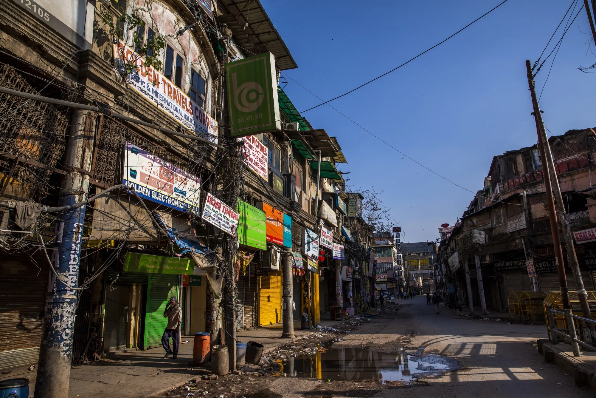 A man walks past shuttered stores near the Khari Baoli spice market in Delhi on March 22.
