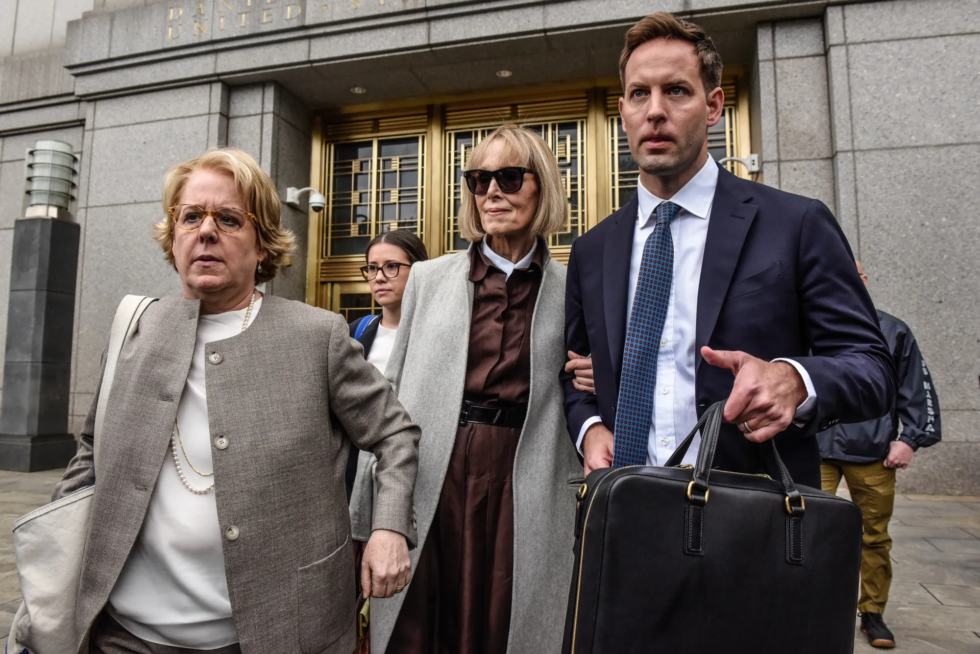 Author E. Jean Carroll, center, leaves federal court in New York in 2023. 