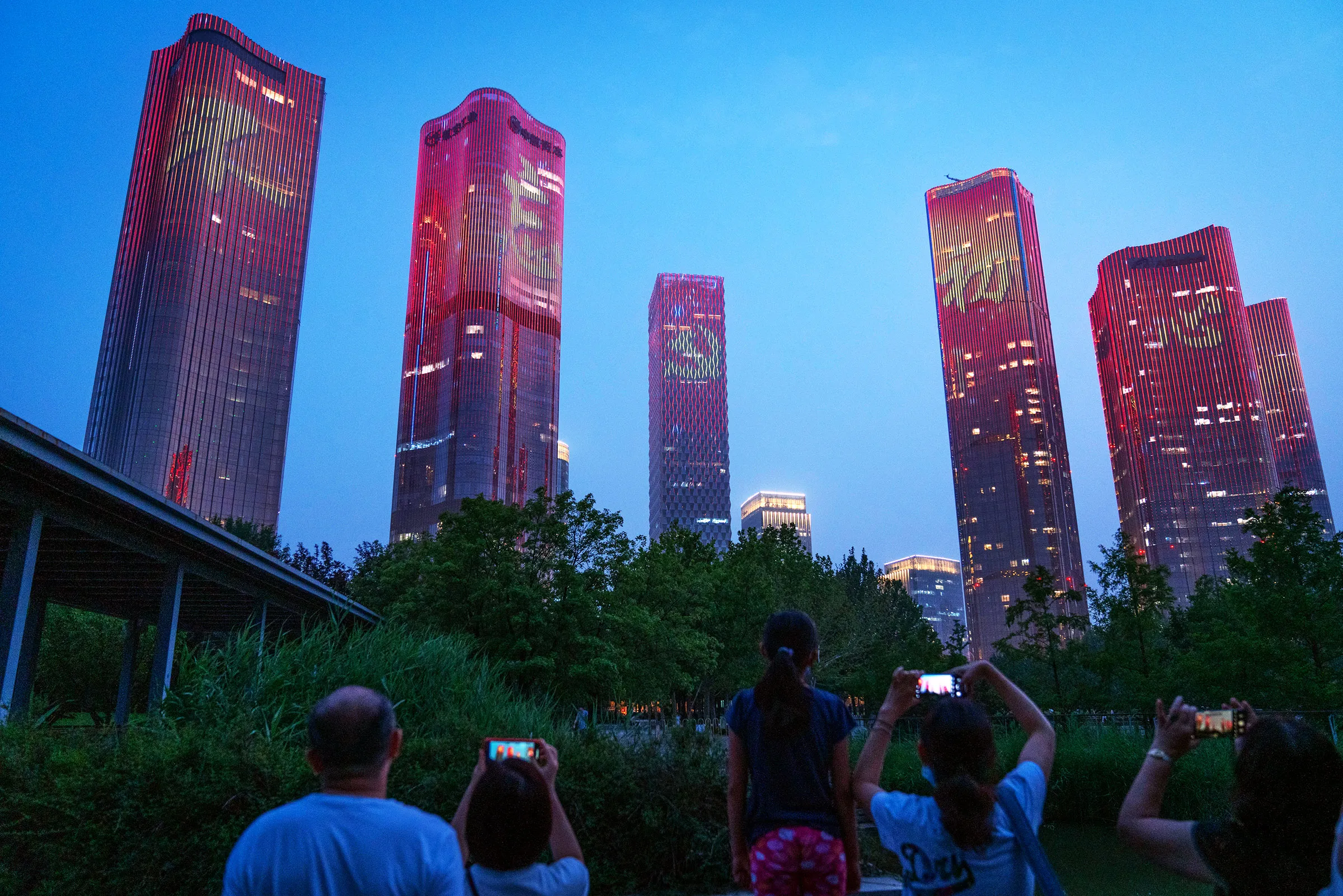Buildings lit up with Chinese characters reading "Never forget the original intention"&nbsp;during a light show marking the centenary of the Chinese Communist Party in Beijing on June 26.