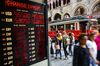 Pedestrians pass a digital sign advertising the latest rates for Turkish lira in the window of a currency exchange bureau in Istanbul, Turkey, on Monday, June 25, 2018. The gains in Turkey’s lira that followed Recep Tayyip Erdogan’selection victory fizzled out as investors worried that the president’s sweeping new powers may stymie efforts to rein in inflation and the widening current-account deficit.