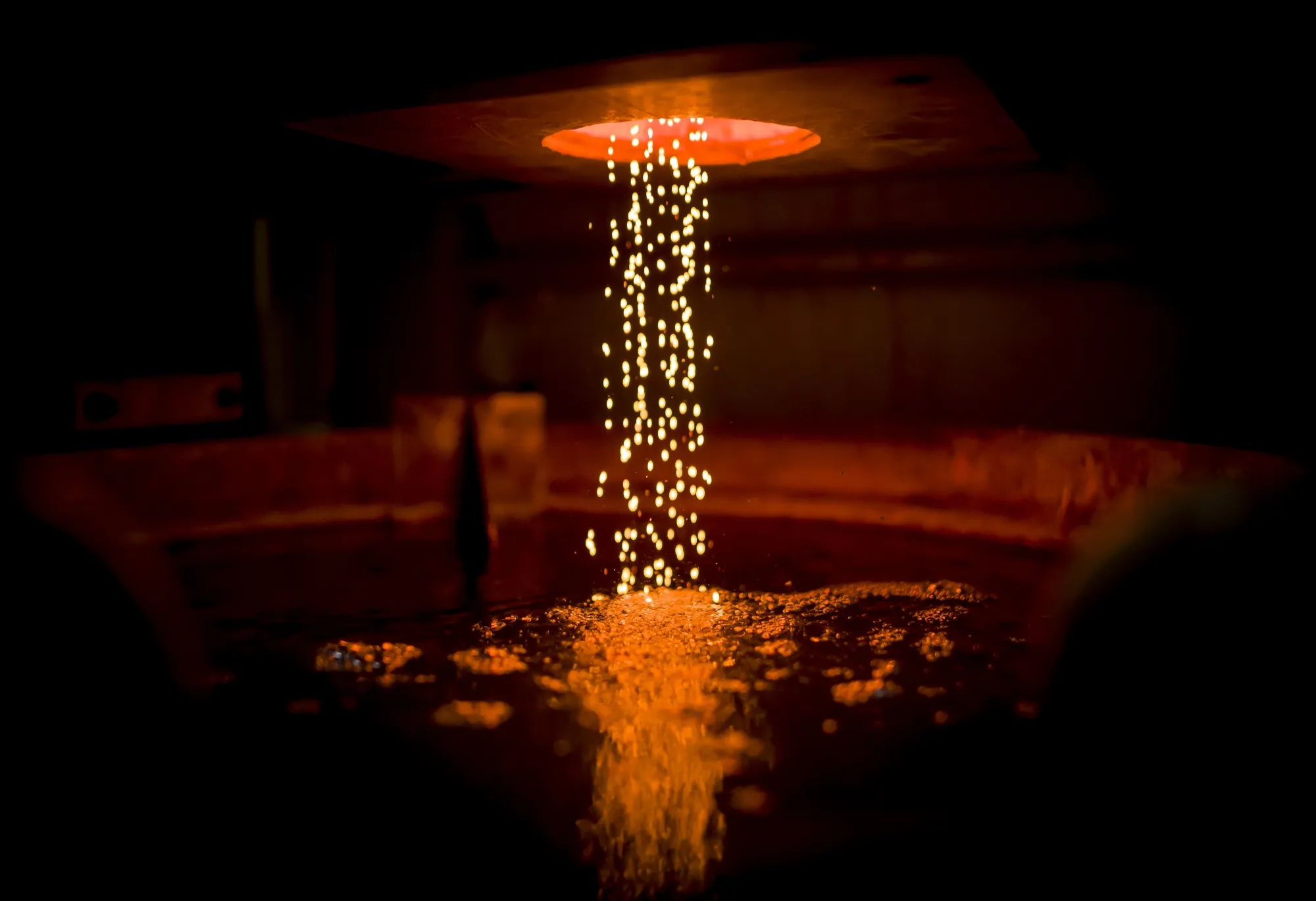 Molten gold poured into a tub of cold water.