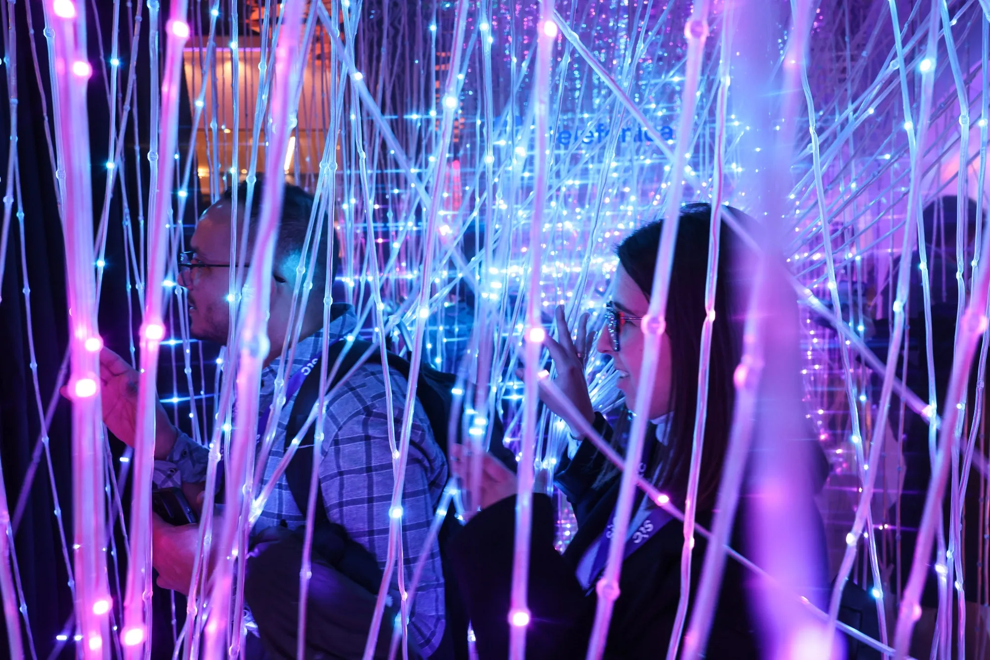Attendees walk through a display of fiber&nbsp;optic cables on the opening day of Mobile World Congress.