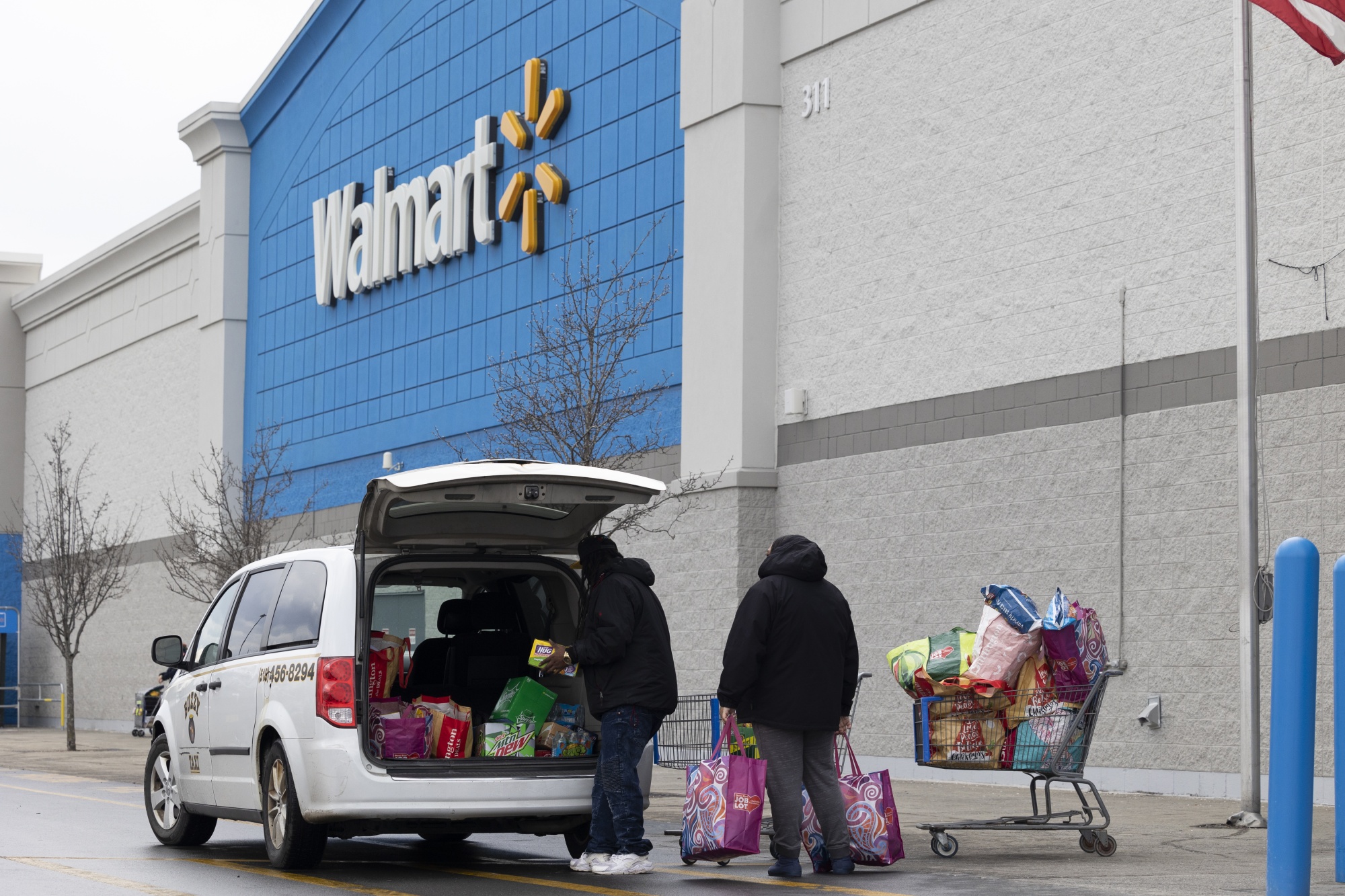 Shoppers load purchases into a vehicle outside a Walmart store in Albany, New York.
