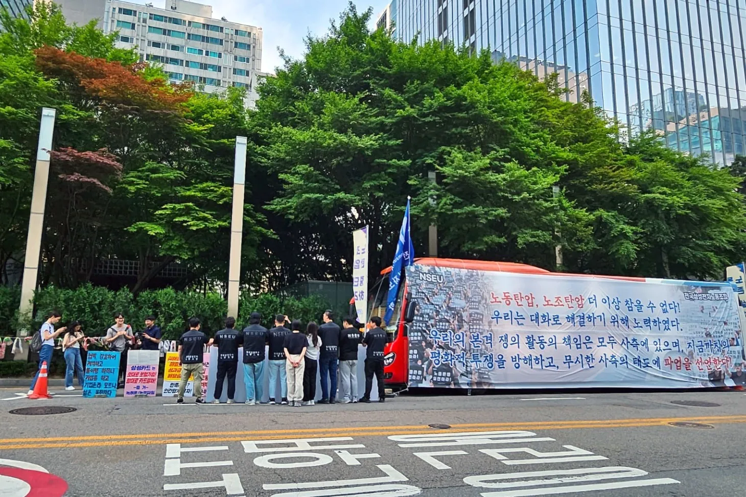 A bus with a banner parked in front of Samsung’s office building in Seoul on June 7.