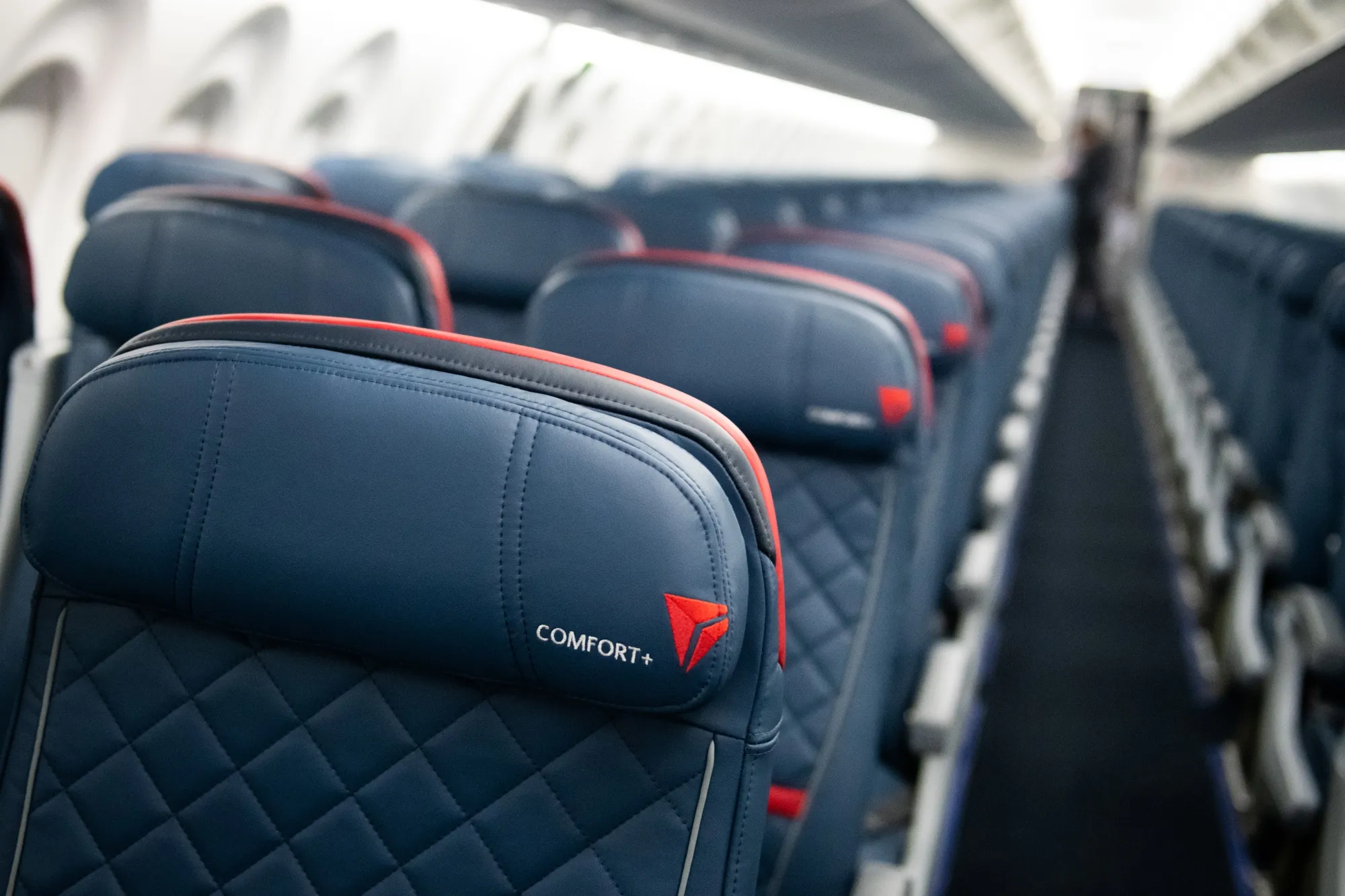 A Comfort+ logo marks a passenger seat on a Delta Airbus A220.