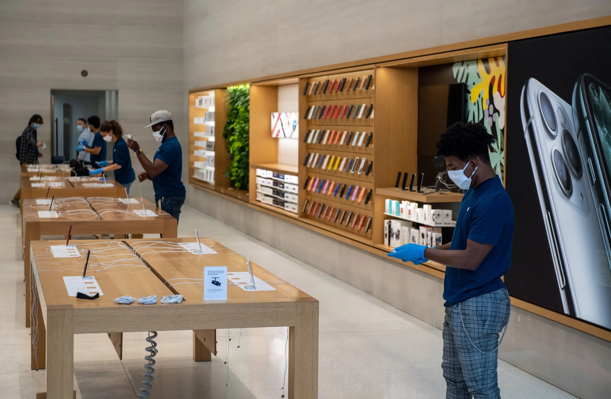 Employees&nbsp;prepare display products inside an Apple store on Regent Street ahead of its reopening in London on June 11.
