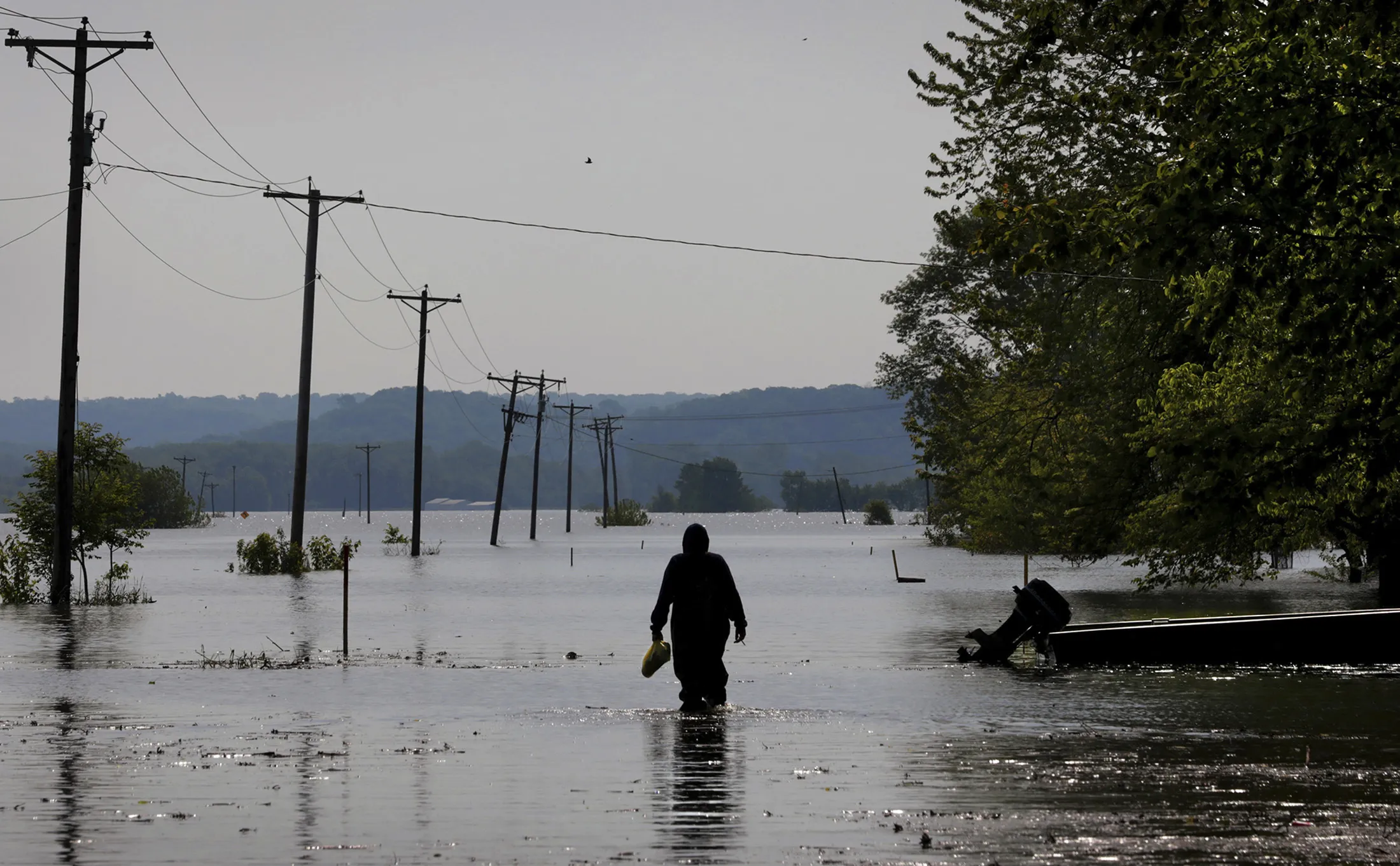 A resident wades through Mississippi River floodwater on May 24, 2019.&nbsp;