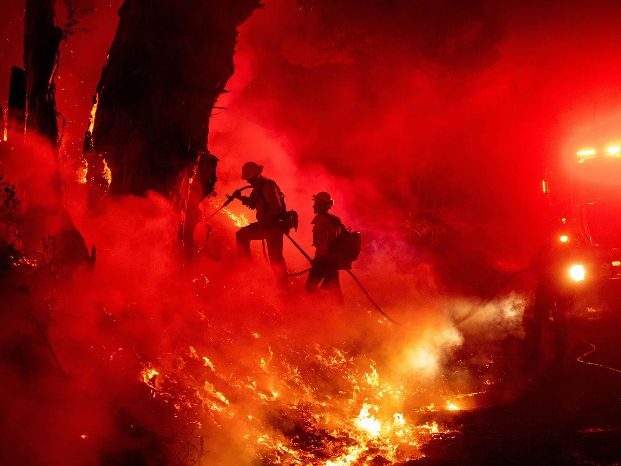 Firefighters work to control flames from a backfire during the Maria fire in Santa Paula, California on Nov. 1.