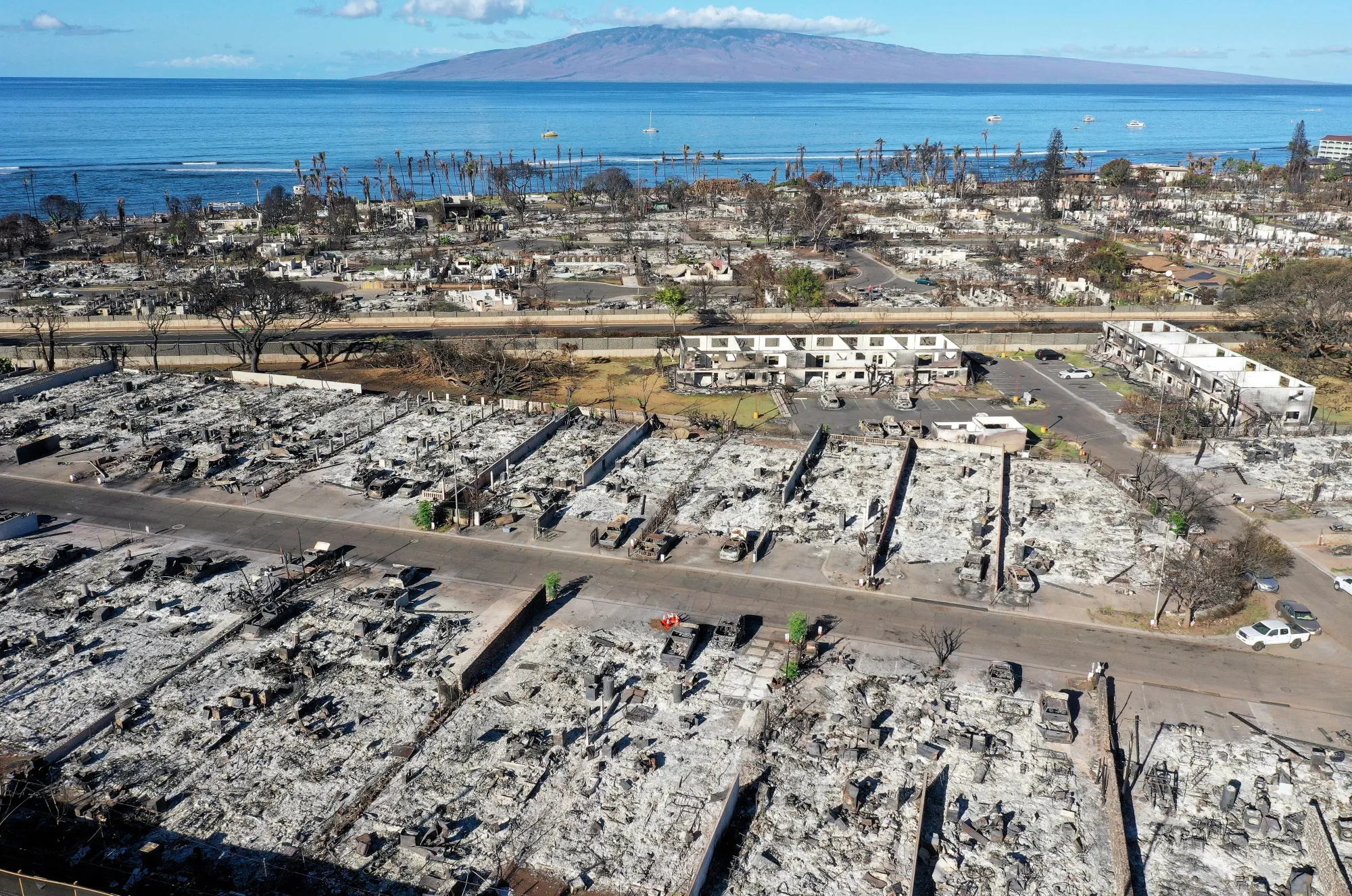 Burned cars and structures in a Maui neighborhood that was destroyed by wildfire.