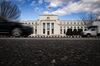 Vehicles pass in front of the Marriner S. Eccles Federal Reserve Building in Washington, DC, USA.