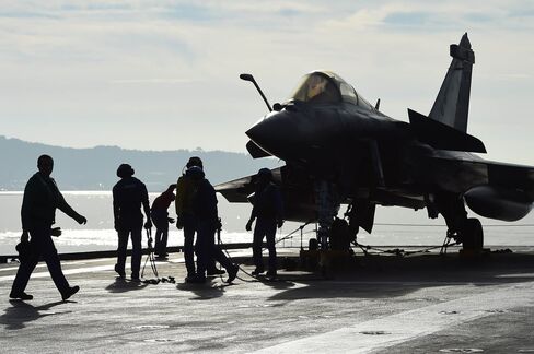 French naval tecnicians work on the flight deck of the aircraft carrier Charles-de-Gaulle