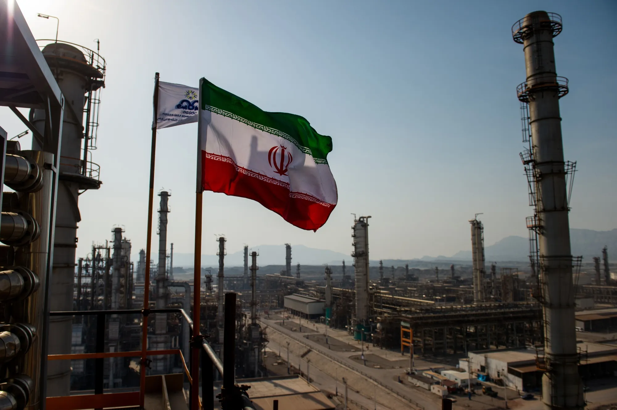 An Iranian national flag flies above a gas condensate refinery in Bandar Abbas, Iran.