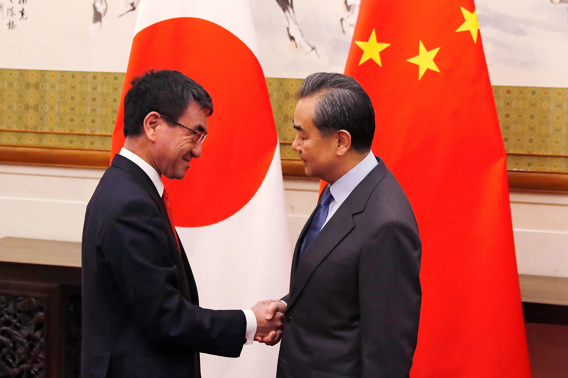 Japanese Foreign Minister Taro Kono, left, shakes hands with Chinese counterpart Wang Yi before a meeting&nbsp;on Jan. 28, 2018 in Beijing, China.&nbsp;