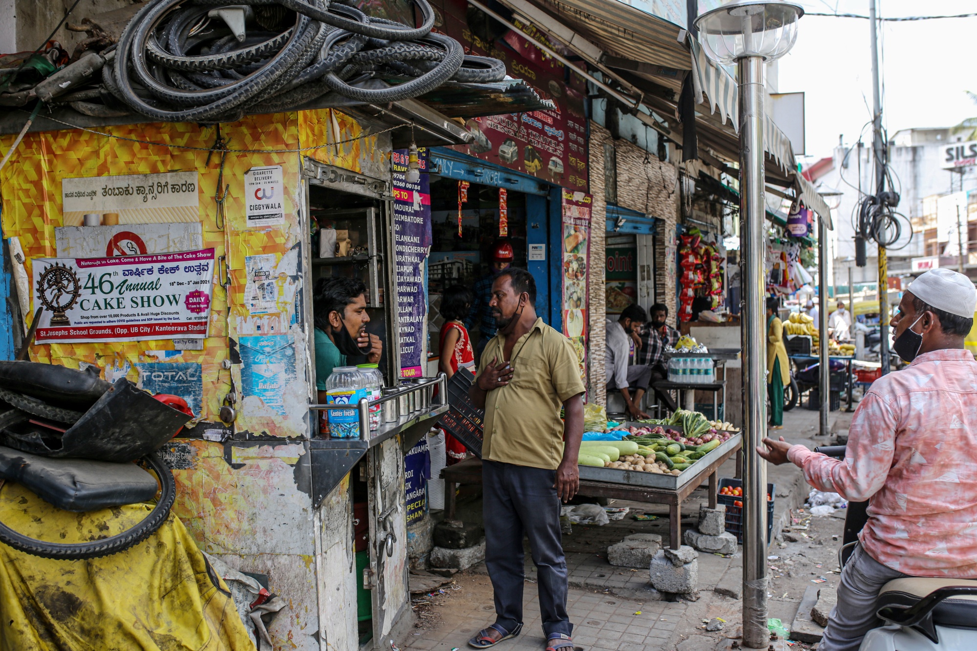 A cigarette vendor speaks to a customer in Bengaluru, India, on Monday, June 21, 2021. The economic disruption caused by the Covid-19 pandemic has brought growth concerns to the top of Indian monetary policy makers’ priority list, and relegated the inflation goal to a secondary position, minutes of the six-member Monetary Policy Committee earlier this month show.
