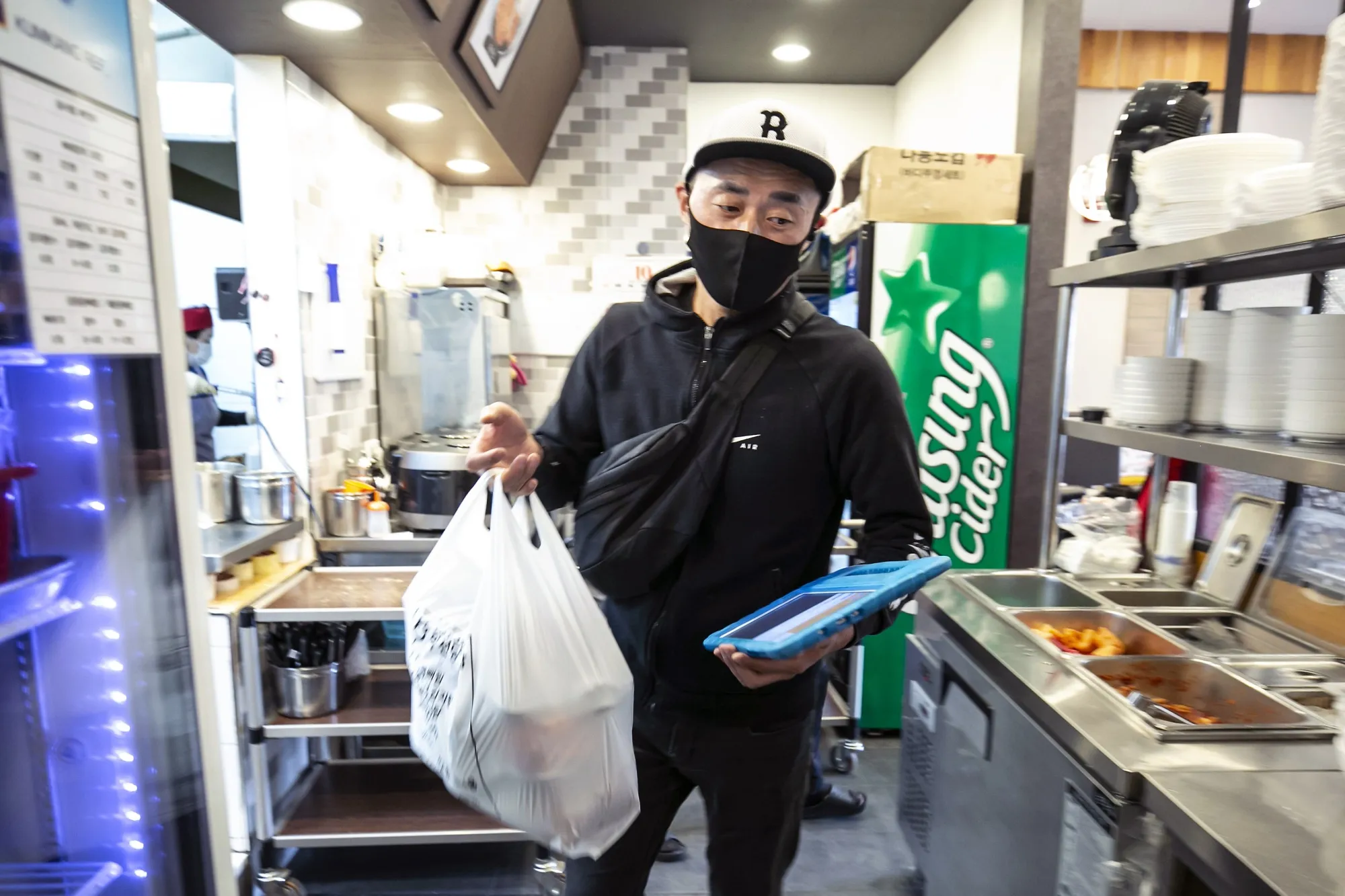 Kim picks up an order at a restaurant in Incheon.