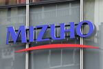 The Mizuho Financial Group Inc. logo is displayed outside a Mizuho Bank Ltd. branch in Tokyo, Japan, on Friday, May 10, 2019. 