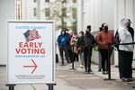 Voters line up for the first day of early voting in Atlanta, Georgia, on Dec. 14.