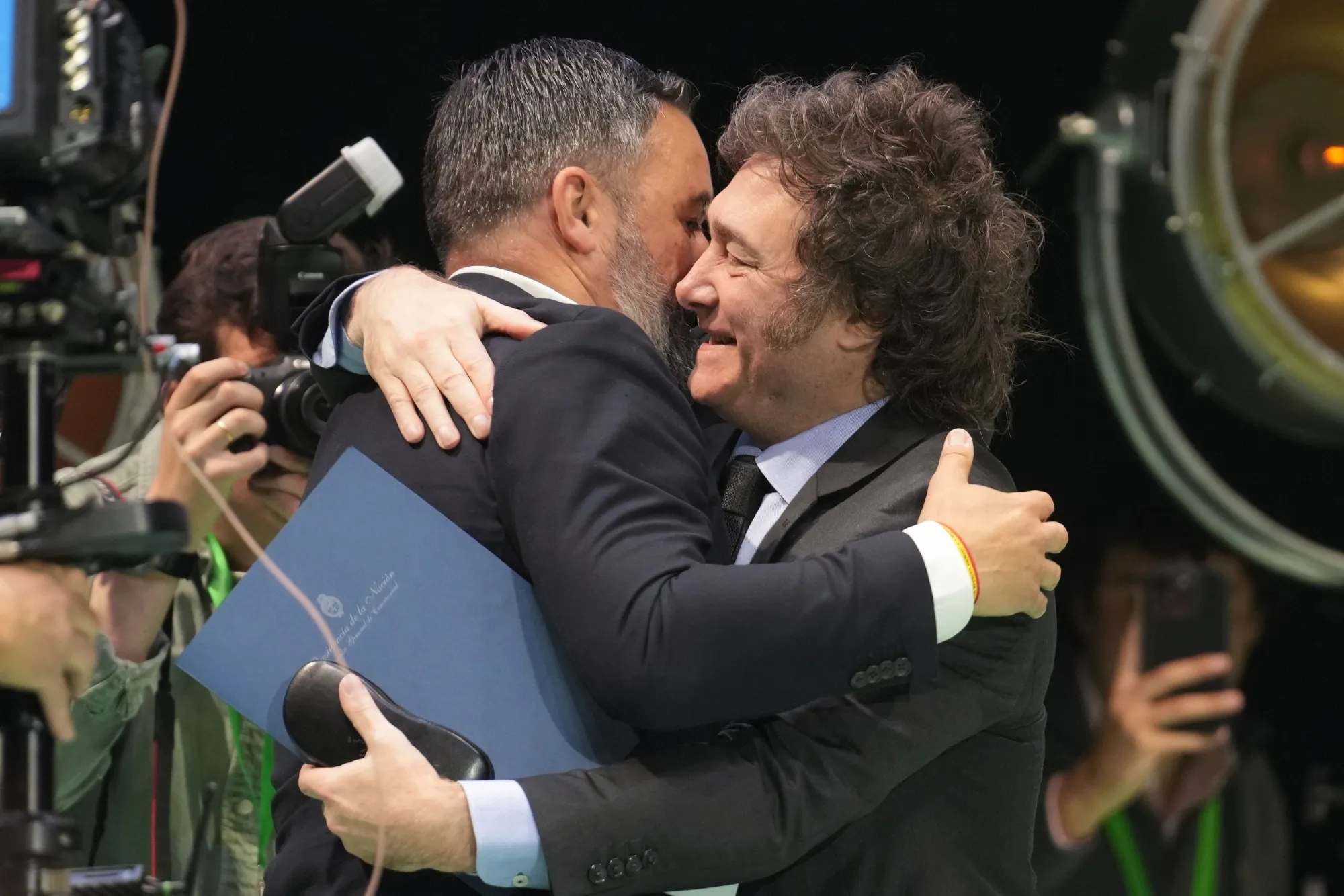 Javier Milei, right, embraces Santiago Abascal at a Vox Party rally in Madrid on Sunday.