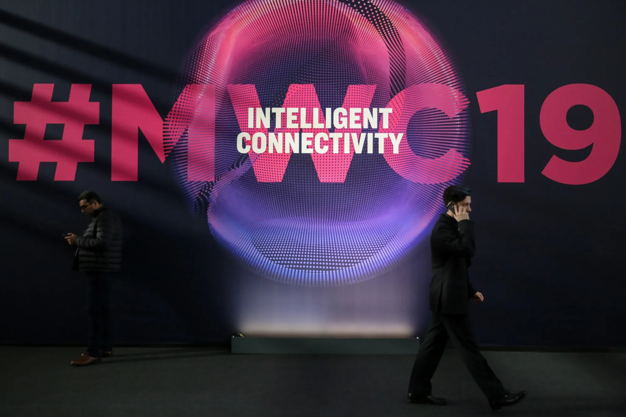 An attendee walks between exhibition halls at the MWC Barcelona in 2019.