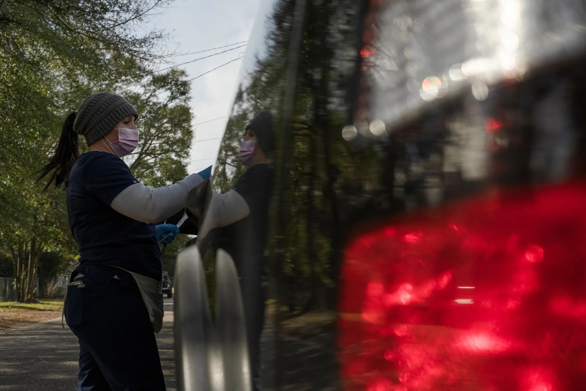 A healthcare worker administers a Covid-19 test at a drive-thru testing site in Sumter, South Carolina on Thursday, Jan. 13, 2022.