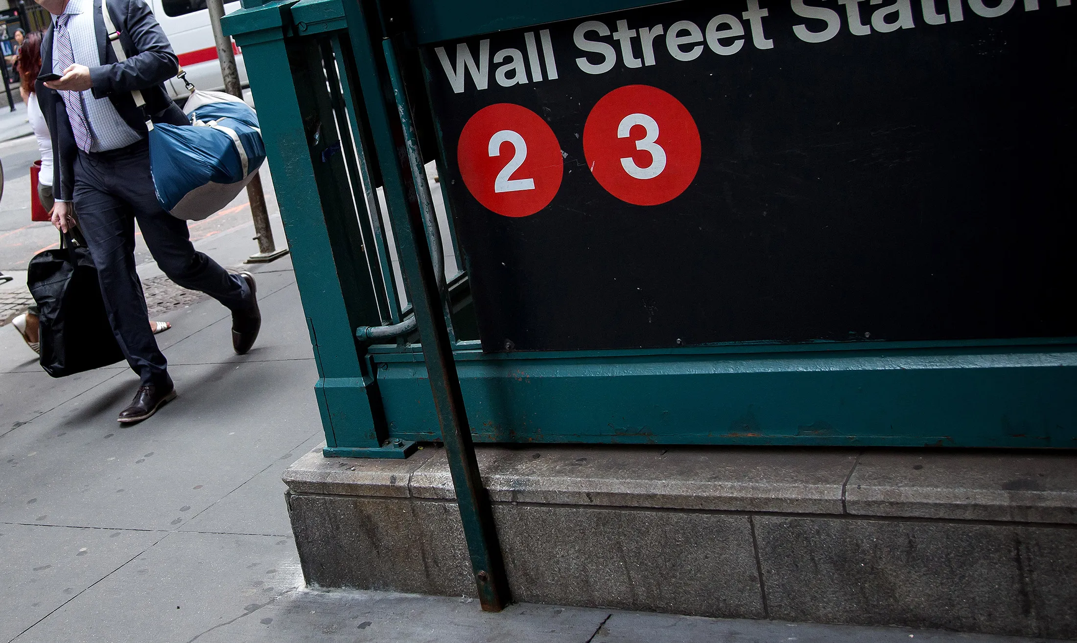 A pedestrian walks past the Wall Street subway station near New York Stock Exchange.
